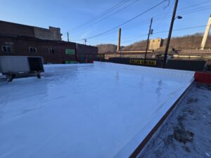 Commercial silicone roof application with EPDM repairs in Monessen, PA.